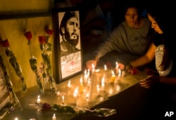 Students place candles around an image of the late Cuban leader Fidel Castro, at the university where Castro studied law as a young man, during a vigil in Havana, Cuba, Nov. 26, 2016.