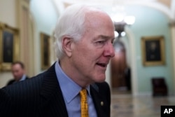 FILE - Senate Majority Whip Sen. John Cornyn, R-Texas, talks with reporters on Capitol Hill, Thursday, Oct. 11, 2018 in Washington.