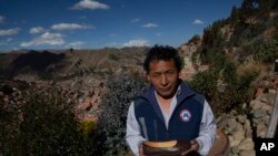 Abraham Rodríguez poses with a finished shoe outside his shoe factory in Villa Rosasani on the outskirts of La Paz, Bolivia, June 27, 2019. Rodríguez says the tax-free import of goods and the black market have affected his sales.