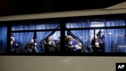 Buses carrying passengers from the quarantined Diamond Princess cruise ship leave a port in Yokohama, near Tokyo, Japan.