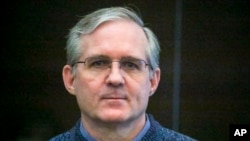FILE - Paul Whelan, a former U.S. Marine who was arrested for alleged spying, listens to the verdict in a courtroom at the Moscow City Court in Moscow, Russia, June 15, 2020.