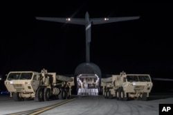 In this photo provided by U.S. Forces Korea, trucks carrying U.S. missile launchers and other equipment needed to set up the Terminal High Altitude Area Defense (THAAD) missile defense system arrive at the Osan air base in Pyeongtaek, South Korea, March 6, 2017.