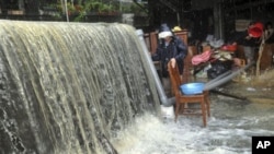 Massive water and flood debris caused by rains from passing Typhoon Megi flow through a residential district in Ilan county, north eastern Taiwan, 22 Oct 2010