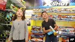 Dua bersaudara melihat-lihat gawai terbaru pada Pekan Mainan Internasional Amerika Utara yang ke-115, di New York, 17 Februari 2018 (foto: AP Images/Amy Suusman)