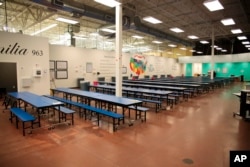 This undated photo provided by the U.S. Department of Health and Human Services' Administration for Children and Families shows part of a shelter used to house unaccompanied foreign children in Brownsville, Texas.
