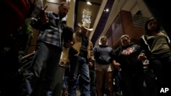 Mourners pray during a vigil to remember victims of a mass shooting in Thousand Oaks, California, Nov. 8, 2018.