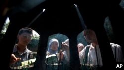 FILE - Muslims burn incense after attending an Eid al-Fitr morning prayer session at the Niujie Mosque in Beijing, August 8, 2013. China is said to be home to more than 20 million Muslims