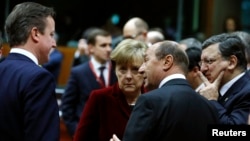 Britain's Prime Minister David Cameron (L-R), Germany's Chancellor Angela Merkel, Romania's President Traian Basescu and European Commission President Jose Manuel Barroso attend a European leaders emergency summit on Ukraine, March 6, 2013.