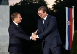 French President Emmanuel Macron, left, and Serbian President Aleksandar Vucic shake hands during an event at Veliki Kalemegdan Park in Belgrade, Serbia, July 15, 2019.