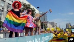 Gay and lesbian rights activists demonstrate as participants of the annual Gay Pride parade wave from a float in Kyiv, Ukraine, June 18, 2017. 