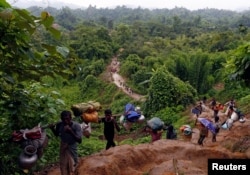 Rohingya refugees climb up a hill after crossing the Bangladesh-Myanmar border in Cox's Bazar, Bangladesh, Sept, 8, 2017.
