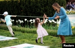 Ibu Negara AS Melania Trump bermain bersama seorang anak dalam perayaan Paskah Gedung Putih di Halaman Selatan Gedung Putih di Washington, 22 April 2019.