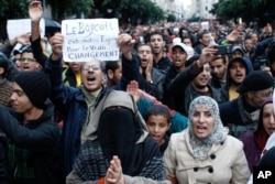 Anti-government protesters shout during a rally organized by the 20th February, the Moroccan Arab Spring movement in Casablanca, Morocco, Sunday, Nov 20, 2011, in a mass popular call to bring more democracy into this North African kingdom.