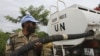 A United Nations peacekeepers soldier prepare to distribute water to the population of Tai, (Ivory Coast) near the border with Liberia, June 18, 2012.
