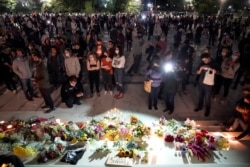 People gather to mourn the death of Supreme Court Justice Ruth Bader Ginsburg, at the Supreme Court in Washington, Sept. 18, 2020.