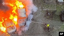 Emergency services personnel work to extinguish a fire following a Russian missile strike in Ukraine's Poltava region, Nov. 17, 2024. (Ukrainian Emergency Service via AP)