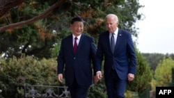 U.S. President Joe Biden, right, and Chinese President Xi Jinping walk together after a meeting during the Asia-Pacific Economic Cooperation leaders' week in Woodside, California, Nov. 15, 2023.