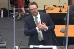 Defense attorney Eric Nelson mimics someone feigning a medical emergency as he makes closing arguments during the trial of former Minneapolis police officer Derek Chauvin for second-degree murder.