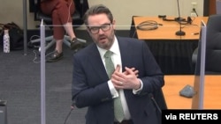 Defense attorney Eric Nelson mimics someone feigning a medical emergency as he makes closing arguments during the trial of former Minneapolis police officer Derek Chauvin for second-degree murder.
