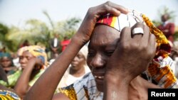 The mother of a missing Chibok girl reacts during a march with other women to the presidential villa in Abuja, Nigeria, calling for their daughters to be brought back home, Jan. 14, 2016.