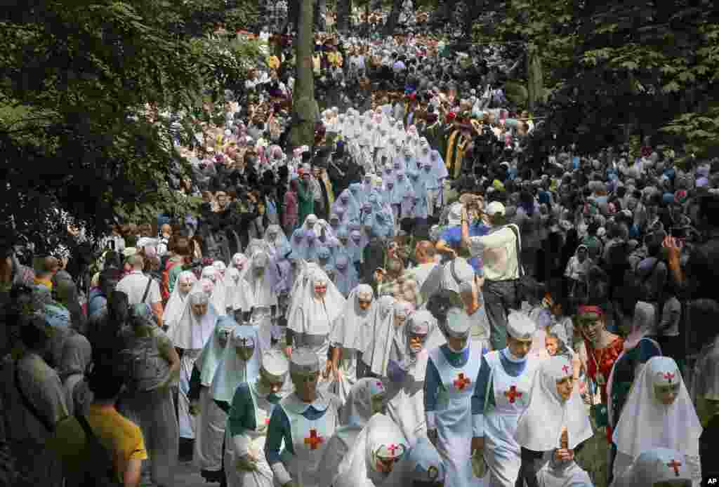 Orthodox believers and clergymen march to prayer in downtown Kyiv, Ukraine, in observance of the holiday marking the adoption of Christianity in the 10th century by what is now Russia and Ukraine.