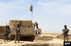 Afghan Border Police personnel keep watch during an ongoing battle between Pakistani and Afghan Border forces near the Durand line at Spin Boldak, in southern Kandahar province, May 5, 2017.