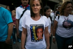 Jineth Frias poses for a photo in a T-shirt featuring her slain son, Bassil da Costa, at an anti-government protest marking the third anniversary of his killing by security forces during weeks of unrest in Caracas, Venezuela, Feb. 12, 2017.