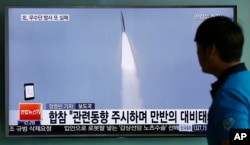 FILE - In this May 31, 2016, file photo, a man watches a TV news program reporting about a missile launch of North Korea, at the Seoul Train Station in Seoul, South Korea.