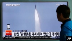 FILE - In this May 31, 2016, file photo, a man watches a TV news program reporting about a missile launch of North Korea, at the Seoul Train Station in Seoul, South Korea.