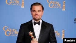 Actor Leonardo DiCaprio poses with the award for Best Actor in a Motion Picture, Musical or Comedy for his role in "The Wolf of Wall Street" backstage at the 71st annual Golden Globe Awards in Beverly Hills, California, Jan. 12, 2014.