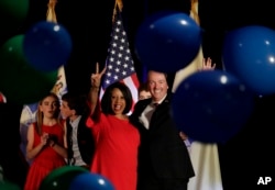 New Jersey gubernatorial nominee Phil Murphy, right, and Lt. Gov. nominee Sheila Oliver wave to supporters as balloons drop during their election night victory party at the Asbury Park Convention Hall, Nov. 7, 2017, in Asbury Park, New Jersey.