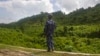 FILE - A Myanmar police officer stands on a road checkpoint in Buthidaung, Rakhine state, on May 28, 2017. The U.N. human rights office warned on May 24, 2024, of “frightening and disturbing reports” of violence against the Rohingya people in Myanmar's Rakhine state. 