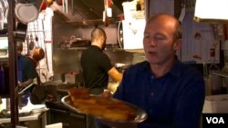 Restaurant owner Stephane Dantier says the neighborhood has had a hard time moving on. (L. Bryant/VOA)