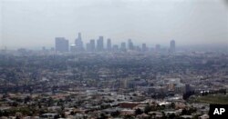 FILE - Smog covers downtown Los Angeles, April 28, 2009.
