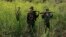 FILE - Rebel soldiers of Myanmar National Democratic Alliance Army (MNDAA) patrol near a military base in Kokang region, March 10, 2015. 