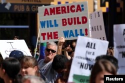 FILE - Pro-Trump supporters try to interrupt a speech by Sen. Kamala Harris, D-Calif., at a rally in support of the Deferred Action for Childhood Arrivals program at the University of California-Irvine, Oct. 11, 2017.