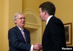 FILE - U.S. Senate Majority Leader Mitch McConnell greets Supreme Court nominee judge Brett Kavanaugh on Capitol Hill in Washington, July 10, 2018.