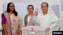 Prime Minister Sheikh Hasina gestures after casting her vote in the morning during the general election in Dhaka, Bangladesh, Dec. 30, 2018.