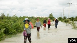 Villagers walk on a flooded road in Phnom Penh, Cambodia, on October 14, 2020. (Malis Tum/VOA Khmer)