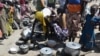 FILE - Women prepare food in a camp for Nigerian refugees in Minawao, Cameroon, Nov. 13, 2014. 