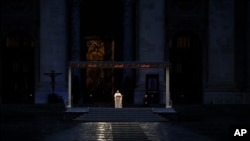 FILE - Pope Francis delivers the Urbi and Orbi prayer in an empty St. Peter's Square, at the Vatican, March 27, 2020.