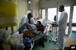 A doctor treats a woman with respiratory difficulties at the emergency room at Sacre Couer hospital outside Beirut, Lebanon, March 3, 2016.