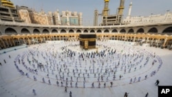 FILE - In this July 31, 2020, photo, pilgrims walk around the Kabba at the Grand Mosque in the Muslim holy city of Mecca, Saudi Arabia. 