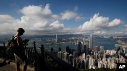 A tourist takes a picture from the Victoria Peak in Hong Kong