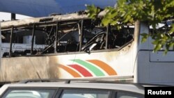 A burnt bus is seen at Bulgaria's Burgas airport July 18, 2012. At least three people were killed and more than 20 injured by an explosion on the bus carrying Israeli tourists Wednesday outside the airport of the Black Sea city.