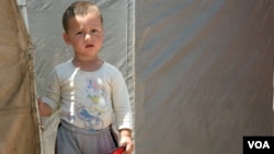 A Child living at the Domiz camp. (Phillip Wellman for VOA)