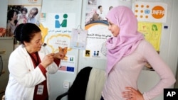 FILE - Actress and UN Population Fund's (UNFPA) Goodwill Ambassador Ashley Judd visits the Zaatari refugee camp in Mafraq, Jordan, April 10, 2016.