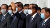 Cambodia's Prime Minister Hun Sen waves during King Norodom Sihamoni's departure to China for a health check-up at Phnom Penh International Airport in Phnom Penh on October 6, 2020. (Photo by TANG CHHIN Sothy/AFP)