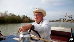 In this Jan. 8, 2019 photo, father Roy Snipes, pastor of the La Lomita Chapel, shows Associated Press journalists the land on either side of the Rio Grande at the US-Mexico border in Mission, Texas.