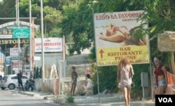 Women from Central Europe — mainly Romania and Moldova — start touting for business earlier than the Nigerians in the morning, but the Nigerians continue much later into the night. (J. Dettmer/VOA)